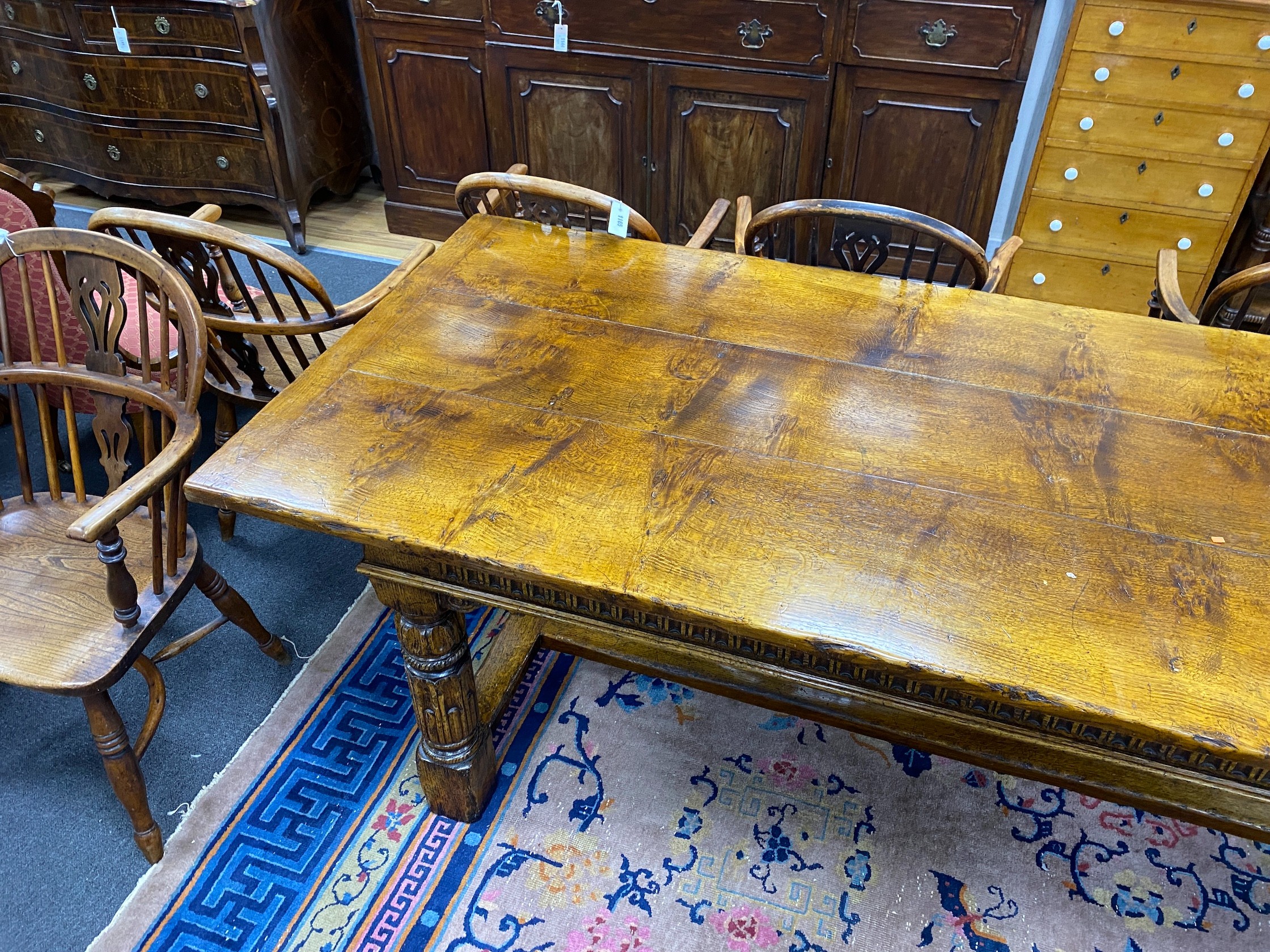 An 18th century style rectangular pale oak refectory dining table with central stretcher and two detachable extending leaves, (lacking three bolts) length 244cm, width 91cm, height 75cm, extending leaves each 46cm